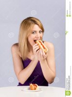 young-blond-woman-eating-hot-dog-ketchup-8840940.jpg