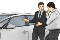 1_How_to_Handle_a_Car_Salesman_car_salesman_talking_to_a_prospective_buyer_next_to_a_car.jpeg