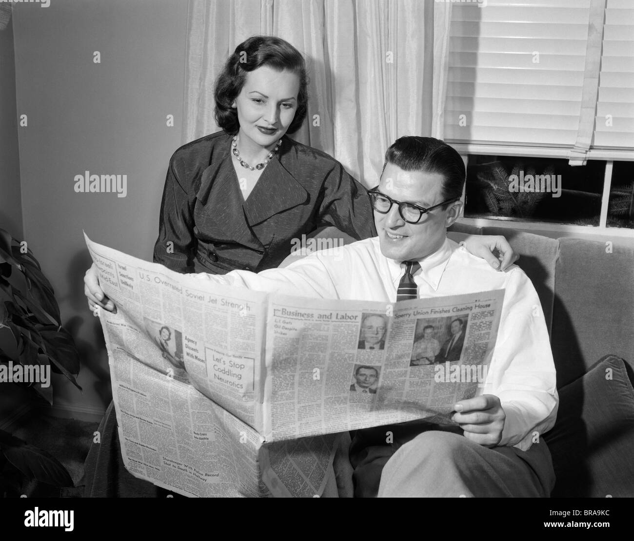 1950s-couple-man-woman-reading-newspaper-BRA9KC.jpg